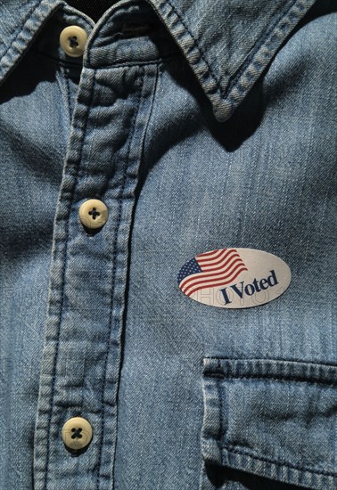 Close-up of I voted sticker on denim shirt