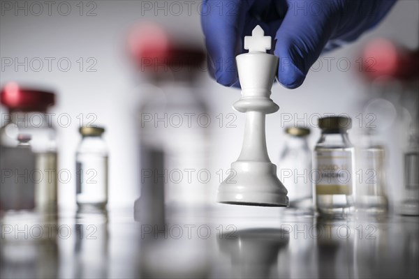 Chess king and laboratory vials