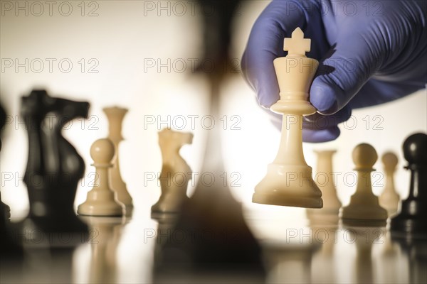 Chess king in gloved hand