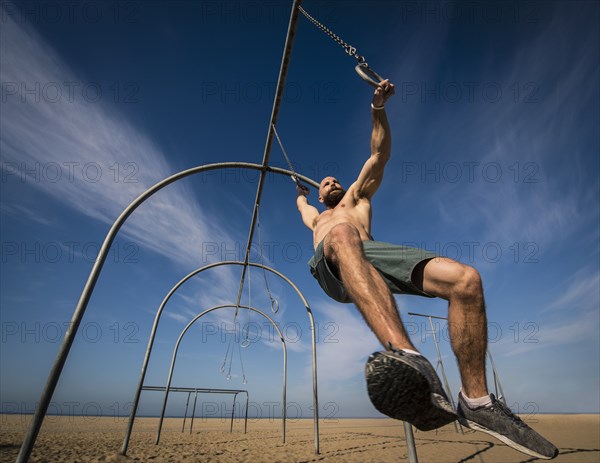 Man exercising on gymnastics rings