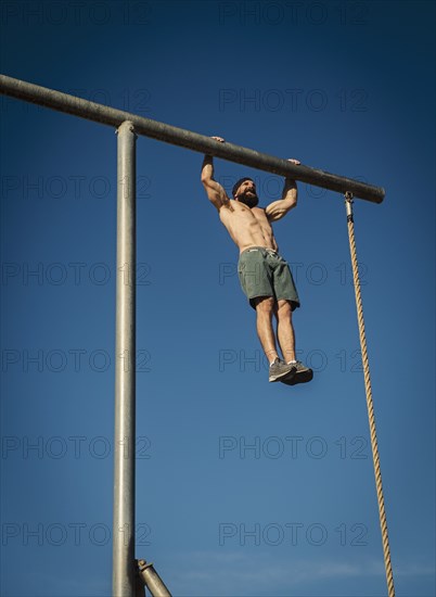 Man exercising on gymnastics bar