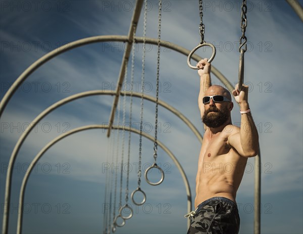 Man exercising on gymnastics rings