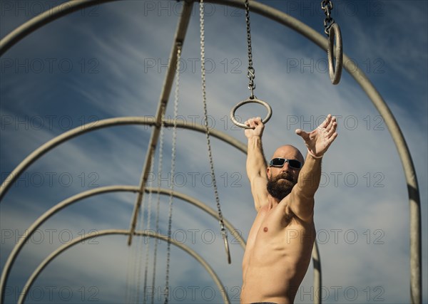 Man exercising on gymnastics rings