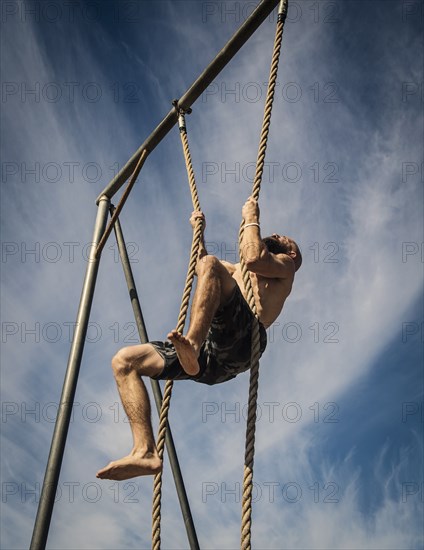 Man exercising on rope