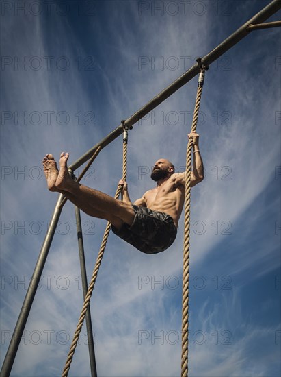 Man exercising on rope