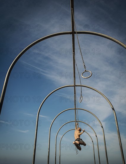 Man exercising on gymnastics rings