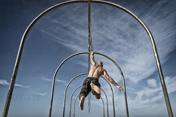 Man exercising on gymnastics rings