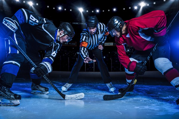 Hockey players and referee starting match