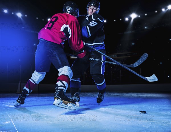 Hockey players fighting for puck