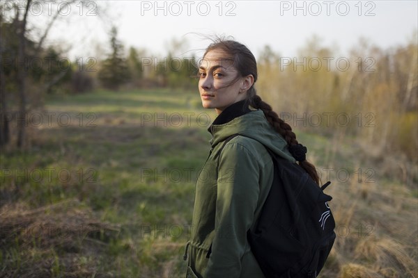 Russia, Omsk, Young woman in meadow