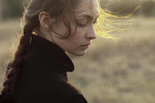 Russia, Omsk, Portrait of young woman in field