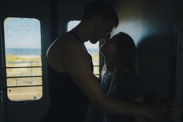 Couple kissing on train