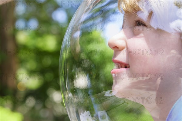 Boy wearing bubble outdoors to socially distance