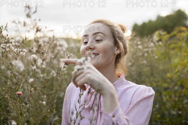 Russia, Omsk, Young woman in meadow