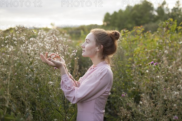 Russia, Omsk, Young woman in meadow