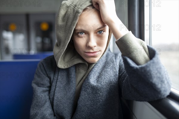 Portrait of young woman in train