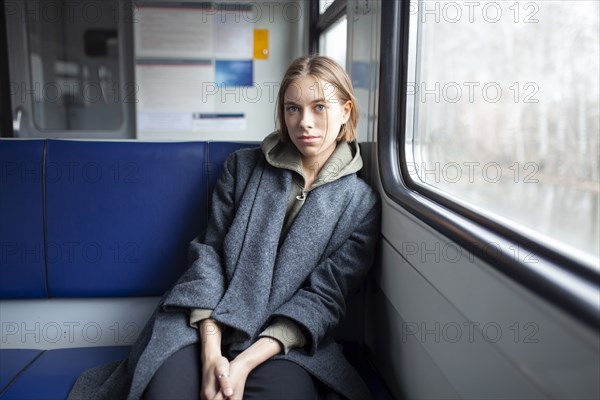 Portrait of young woman in train