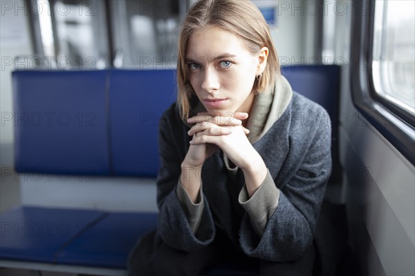 Portrait of young woman in train