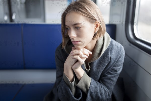 Portrait of young woman in train