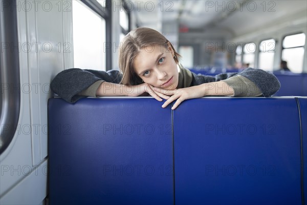 Portrait of young woman in train