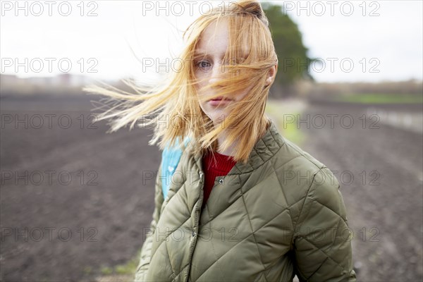 Russia, Omsk, Portrait of young woman in field