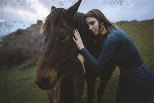 Ukraine, Crimea, Young woman embracing Icelandic horse