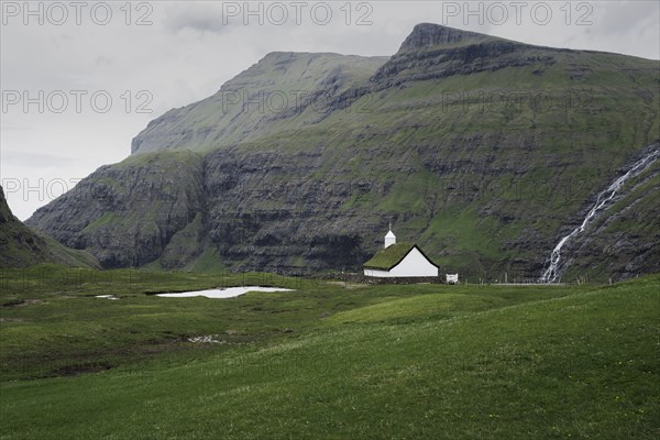 Denmark, Small church in green landscape with mountains,