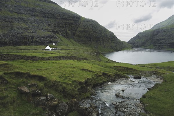 Denmark, Small church in green landscape with mountains,