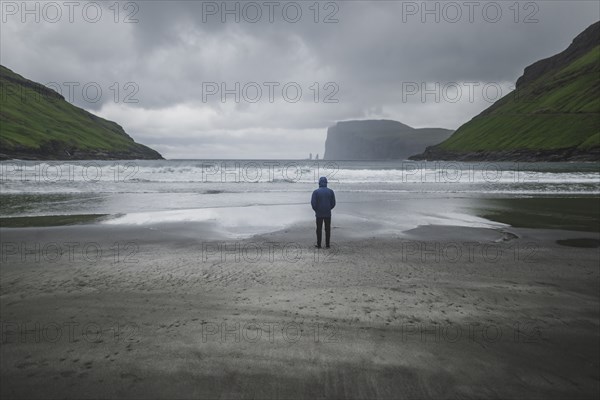 Denmark, Man standing on beach in foggy day,