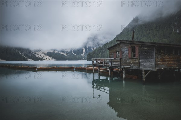 Italy, Wooden house and boats at Pragser Wildsee,