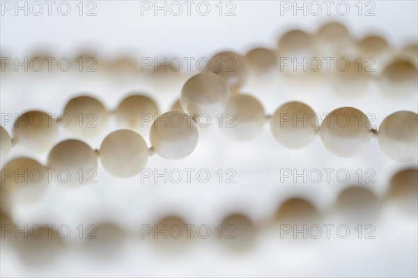 Close up of pearl necklace on white