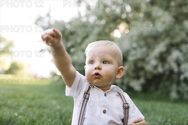 Outdoor portrait of baby boy in park