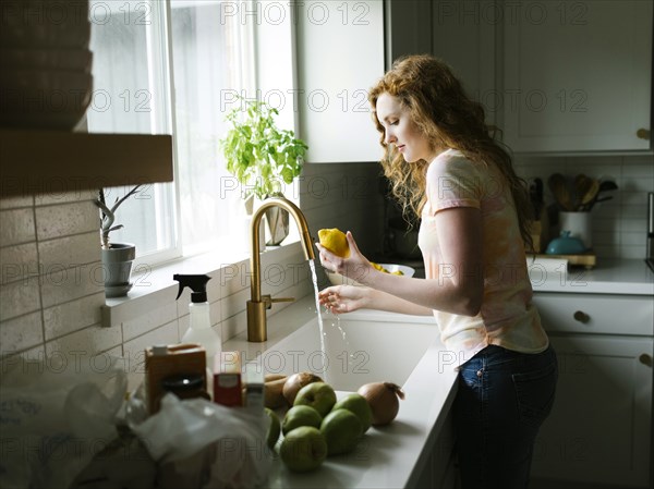 Woman washing lemon