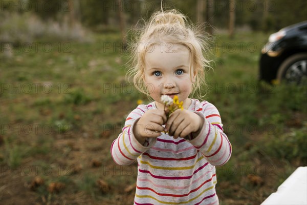 Portrait of girl (2-3) holding flowers