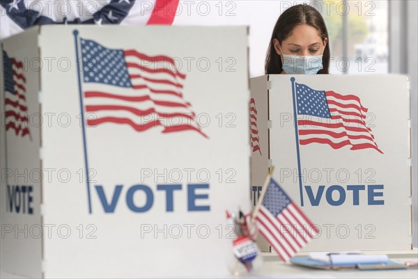 Woman in face mask voting