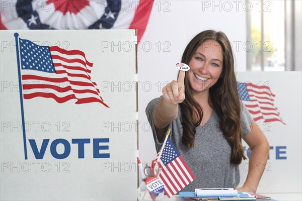 Woman holding voting sticker