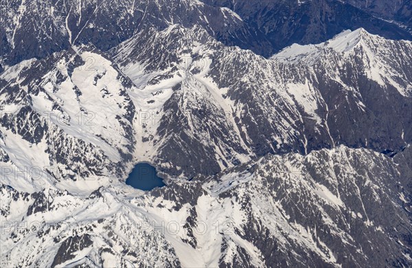 Switzerland, Canton Wallis, Lake among snowy mountains