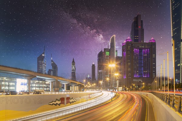 United Arab Emirates, Dubai, Traffic on highway and modern city architecture at dusk