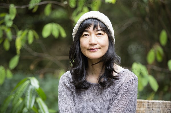 Japanese woman sitting in garden