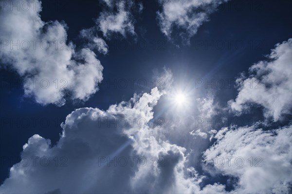 White clouds and sun on blue sky