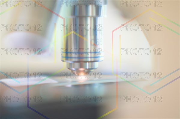 Close-up of laboratory microscope lens with chemical symbol