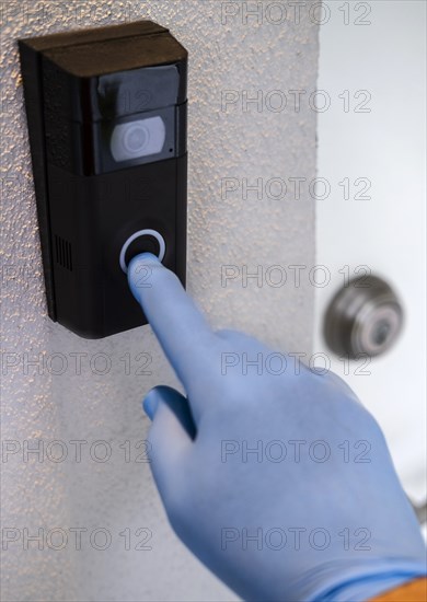 Hand with surgical on door bell