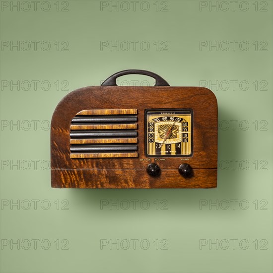 Retro wooden radio on green background