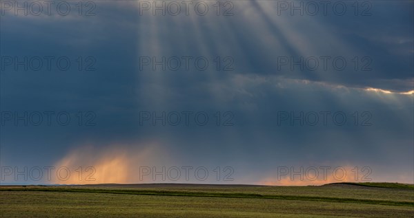 USA, South Dakota, Storm clouds at sunset over prairie