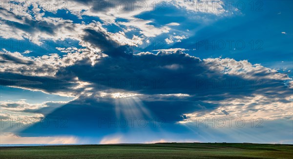 USA, South Dakota, Clearing storm clouds at sunset over prairie