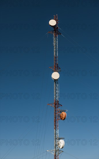 Communication tower against blue sky