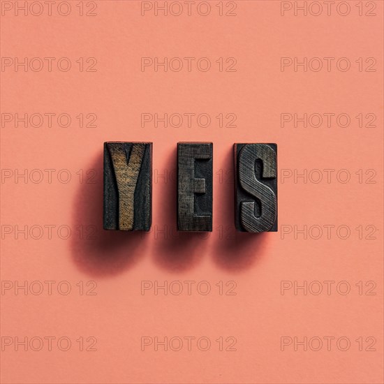 Wooden printer font letters spelling word Yes
