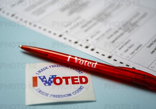 Voting form with pen and badge on blue background