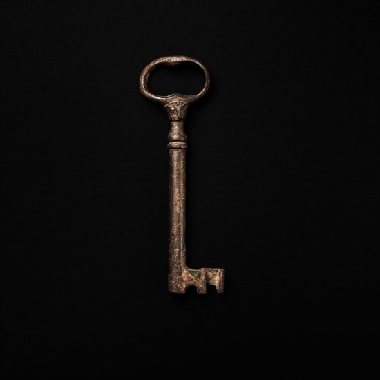 Antique key on black background