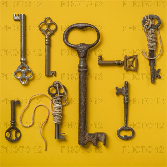 Antique keys on yellow background